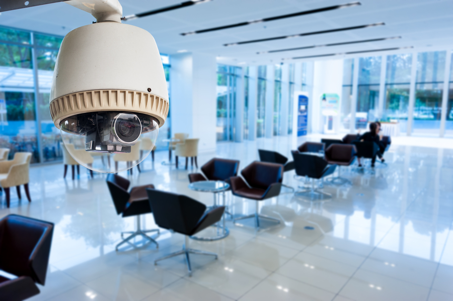 A waiting room in a corporate space being overviewed by a surveillance camera.