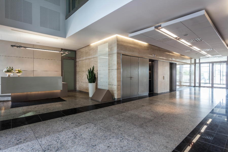 Lobby of an office building featuring polished marble floors.
