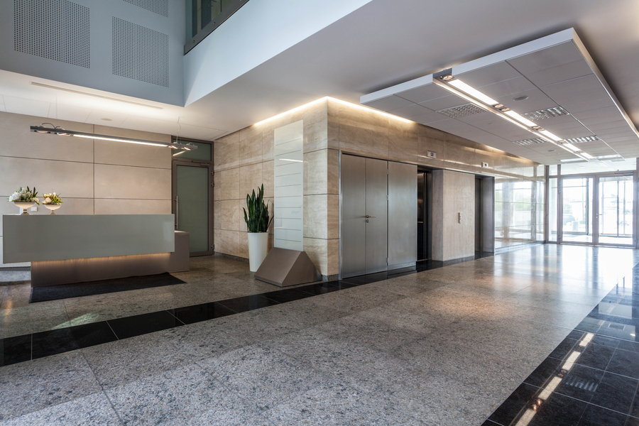 Image is of a commercial office with commercial doors and a modern lobby.