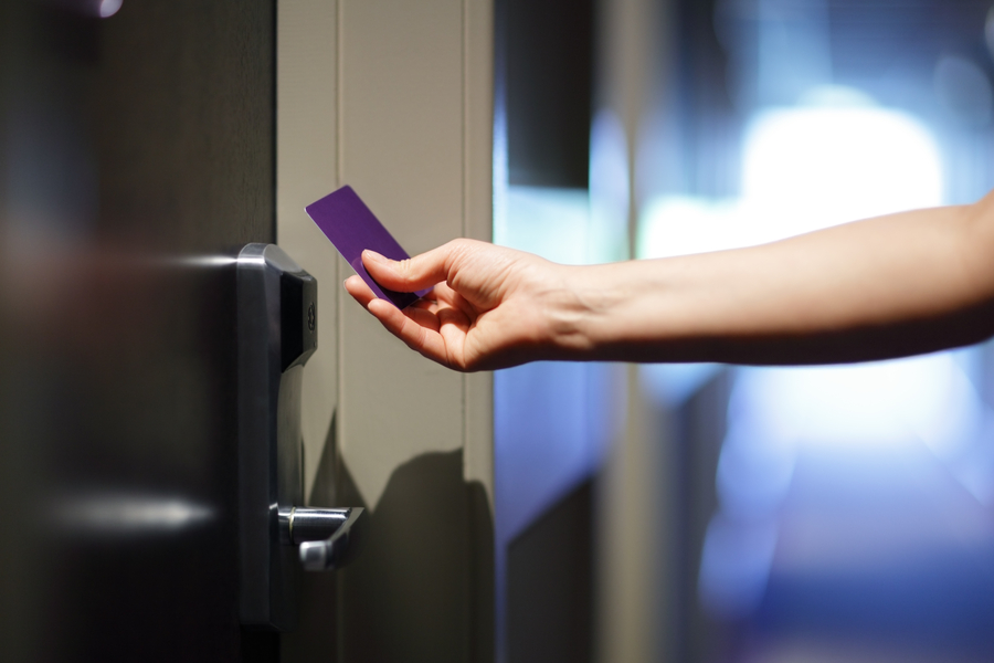 Key card held up to a commercial door lock box.