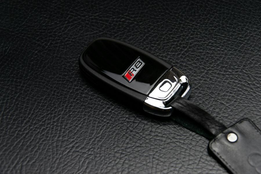 A car fob on a leather surface.